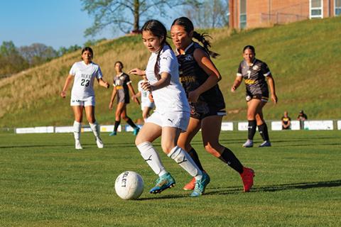 Cannon Crompton/sports@cherokeescout.com Annie Tran (left) of Tri-County Early College runs with the ball as Tina Bui of Murphy defends on April 16. 