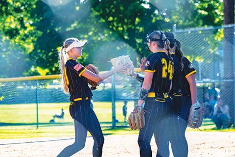 Cannon Crompton/sports@cherokeescout.com Murphy shortstop Julia Dockery (left) high-fives her teammates after they recorded an out against Cornerstone Charter on May 6 in the first round of the state 1A playoffs.
