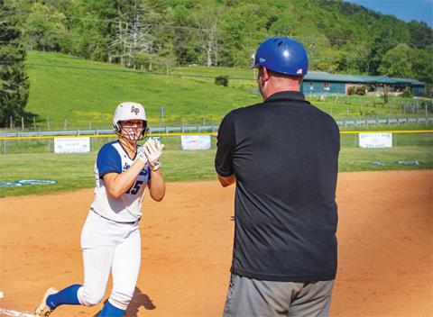 Cannon Crompton/sports@cherokeescout.com Hiwassee Dam senior Olivia McNabb (left) plays rock, paper, scissors against Lady Eagles head coach Chet Kendall after hitting a home run on April 29. 