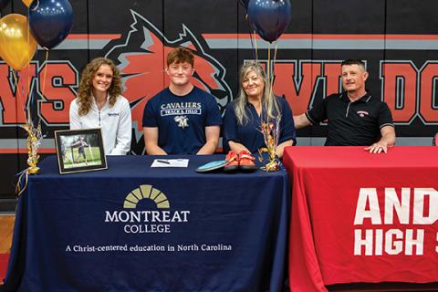 Cannon Crompton/ sports@cherokeescout.com Andrews track & field athlete William Wood (second from left), who specializes in discus, signed a letter of commitment Friday afternoon to continue his athletic and academic career at Montreat College in Black Mountain. Wood holds the discus record at Andrews High School. He will be majoring in exercise science while at Montreat. Pictured with Wood (from left) are Montreat track & field associate head coach Holland McCoy; his mother, Misty Wood; and his father, Tim