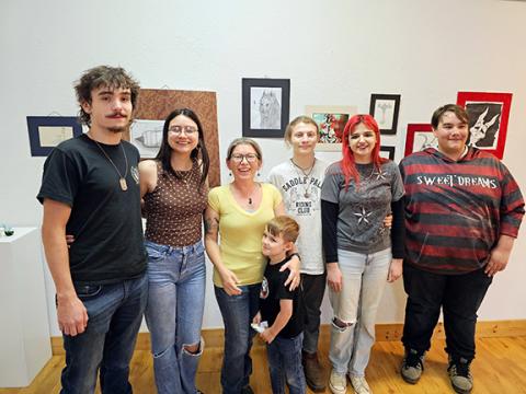 Photos by Nicole Wright/Staff Correspondent Students and alumni from Hiwassee Dam High School join art teacher Christen Clonts at the Cherokee County Arts Council Student Awards ceremony on April 25. Four Hiwassee Dam students took home awards, including two first-place winners. From left are alumni Colton Mills and Yovana Ermosa; students Trenton Pittman, Bo Meyers; art teacher Cristen Clonts and son James Clonts; and student Kenneth Bohannon, who placed first in the 3D category and sold his ceramic piece 