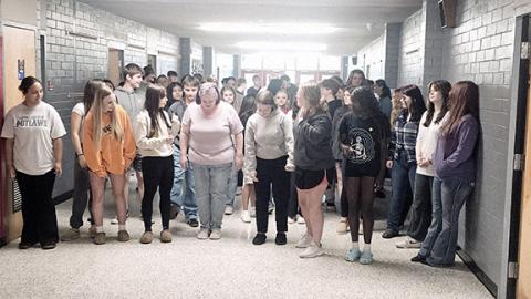 Nicole Wright/Staff Correspondent Science teacher Christina O’Dell gets ready to do the “Toosie Slide” down the hallway at Andrews High School as part of the week-long Teacher Appreciation Week celebration and Survivor/Wheel of Fortune challenge at Andrews High School. O’Dell, the ultimate winner of the challenge, gathered the most students to dance and won a variety of local gift cards. 