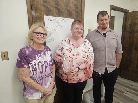 Nicole Wright/Staff Correspondent From left, Kelly Bryant, Andrews Friends of the Library president; Jacqueline Hulse, Andrews Public Library manager; and Franklin Shook, director of the Nantahala Regional Library, at Hulse’s 25th anniversary celebration of employment with the system. Hulse was happily surprised during a meeting on April 17.