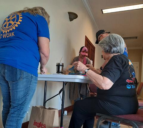 Anngee Quinones-Belian/Staff Correspondent Members of the Rotary Club of Murphy gathered on April 14 at the Educate for Success building to assemble dental kits that will be distributed to an estimated 3,100 students in Cherokee County.