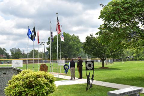 Anngee Quinones-Belian/Staff Correspondent Cherokee County Sheriff Dustin Smith and Capt. C.R. Swanson honor fallen officers by placing a wreath during a memorial service Thursday.