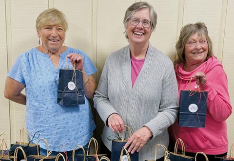 Randy Martins, Catherine Yost and Jane Kvetko (from left) show off the gift bags that have been put together for Saturday's Women's Health Forum in Andrews.