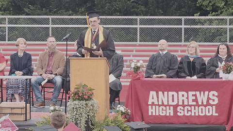 Nicole Wright/Staff Correspondent Class President Wesley Morgan gives his speech, while Cherokee County Board of Education members and faculty look on, at Andrews High School’s graduation Thursday.