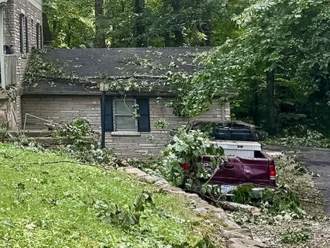 Randy Foster/editor@cherokeescout.com This house off Junaluska Road near Andrews was among the more seriously affected by Saturday’s storm. The house was surrounded by tree limbs and downed mature trees, damaging the vehicle parked out front.
