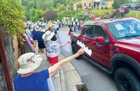 Randy Foster/editor@cherokeescout.com “No King” protesters line up along U.S. 64 Business in Hayesville on Saturday morning.
