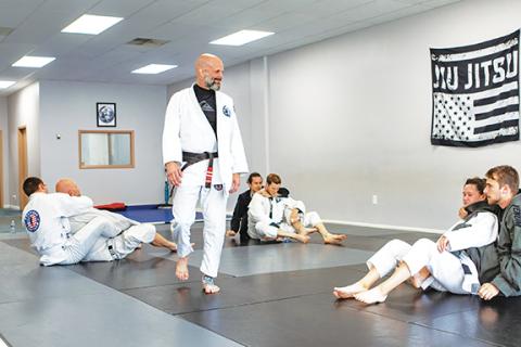 Cannon Crompton/sports@cherokeescout.com Murphy Family Brazilian Jiu-Jitsu Center professor Vincent Werner observes while athletes roll during the adult class.