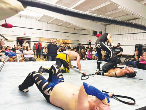 Cindy Ray/Contributing Photographer Vito and KZ Smith beat up Flex Ferguson and Frodo during the main event of the ACWF’s show Saturday night in Peachtree.