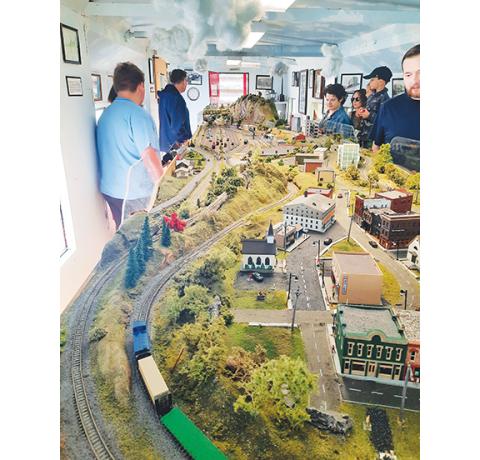 Photos by Anngee Quinones-Belian/Staff Correspondent  Model train enthusiast Paul Jakubiak has brought back to life the model trains that once traveled about a mini-version of the towns of Murphy and Andrews. Young, and young at heart, entered the bright red train caboose at the L&N Depot in downtown Murphy on May 24, to see the impressive display, which ran alongside the weekly farmers market. The train caboose was clean and spiffy for the model train show, as it had been washed earlier by the Mayor’s Risi