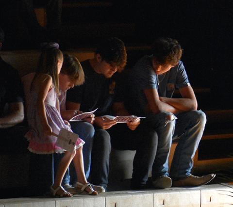 Randy Foster/editor@cherokeescout.com Spectators at Saturday morning’s commencement at Hiwassee Dam High School study the program before the start of the ceremony.