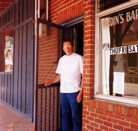 A.V. Hardin stands at the door of the barber shop that his father, Pearlie Hardin, opened in 1946 after moving from Depot Street. Pearlie opened his first barber shop in the early 1920s. 