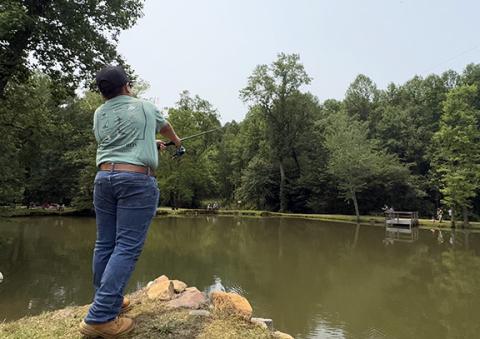 Photos by Randy Foster/editor@cherokeescout.com Casting a line: Anthony DaSilva, 13, of Murphy, casts his line in a pond during the annual Kids Fishing Day at the Cherokee County Sheriff’s Office shooting range in Marble on May 28. He was there with his parents, Grace and Chris DaSilva, and brother, Kyle, 7. The event drew dozens of families.