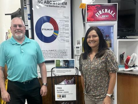 Keeping kids safe: Mountain Projects preventionist Mark Pilon presents an alcohol lock display to Murphy ABC store manager Olivia Anderson.