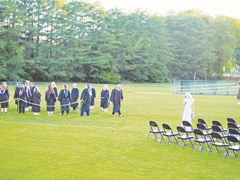 Sam Jokich/Staff Correspondent Everyone wanted to capture an image when the Murphy Bulldogs’ Class of 2025 graduated Friday night.