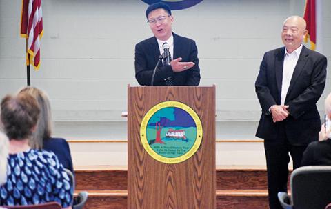 Kevin Hensley/editor@grahamstar.com EcoKing Solution Chair Ping Zhang speaks during a July 22 press conference at the Graham County Community Building, when the China-based manufacturer announced it will create at least 300 new jobs just to start in the region during its first phase of operations in Robbinsville. At Zhang’s left is vice president John Lin.