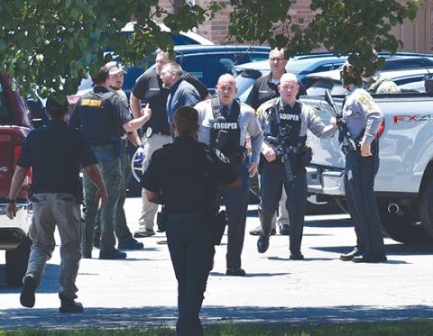 Randy Foster/editor@cherokeescout.com Law enforcement from several agencies collect at 75 Medical Park Lane in Peachtree on Monday afternoon following the deadly shooting of a detention center officer escorting an inmate to a medical appointment. Gov. Josh Stein ordered all U.S. and N.C. flags to be flown at half-staff through sunset Tuesday in honor of Officer Francisco Flattes.