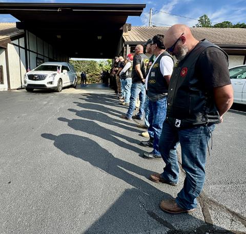 Randy Foster/editor@cherokeescout.com Veterans and law enforcement personnel stand in formation as the casket bearing the remains of Transport Detention Officer Francisco Flattes is removed from a hearse at Townson-Rose Funeral Home on Thursday. Flattes’ remains were returned to Murphy following an autopsy in Winston-Salem, with an escort by emergency responders.