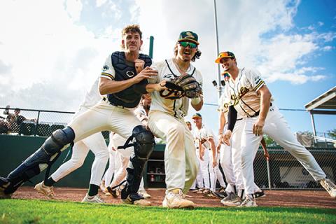 Photos by Tommy Thorpe/Contributing Photographer The Forest City Owls make a tunnel as infielder and Rutherfordton native Kael Snethen (middle) makes his way onto the field during the starting lineup announcement.