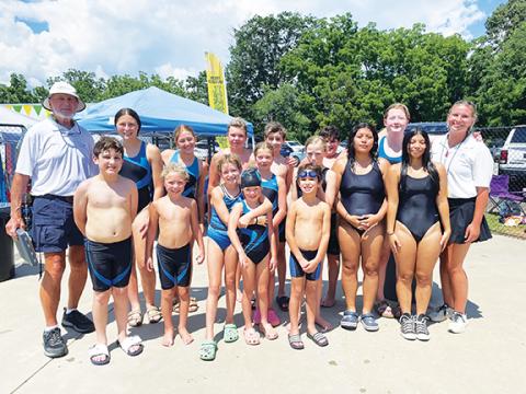 Krista Colandrea/Contributing Photographer The Cherokee County Aquatic Club at the conference meet Saturday. Front row (from left): Maxx Colandrea, Elijah Whitney, Oceana Vaughn, Opi Whitney, PH Hernandez, Jenni Ramirez-Jaime, Bryanna Ramirez-Jaime. Back row (from left): coach Frank Bachteler, Sophia Evans, Estelle Vaughn, Connor Whitney, Mateo Colandrea, Nico Kissel, Ada Lovelace and coach Katy Cook.