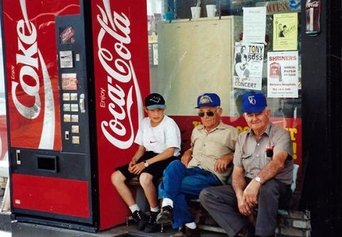 Gerald Trull warmed the bench in front of his gas station with the regulars and once said, “I believe I’ve seen the whole world go by here.” Shown with Gerald Trull (right) are Shane Smith and Ray Smith (from left). 