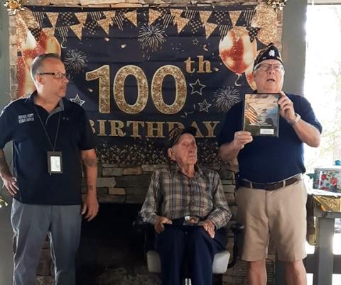 Anngee Quinones-Belian/ Staff Correspondent Richard Millett (left) with Cherokee County Veteran Services in Murphy and Commander Bob Strawhecker with American Legion Post 96 celebrate the 100th birthday of Navy veteran Hoke Henson, each presenting him with a gift.