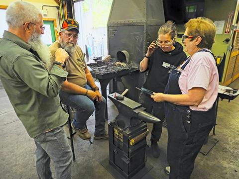 Sam Jokich/Staff Correspondent Heavy metal: John C. Campbell Folk School in Brasstown is celebrating its 100th anniversary this year. Folks in the blacksmith shop are busy creating new works of art.