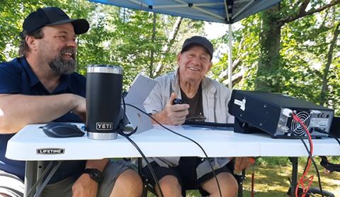 Anngee Quinones-Belian/Staff Correspondent Jeff Dodd (left) instructs Guy Langellotti on high-frequency radio usage at Fields of the Wood on June 28.