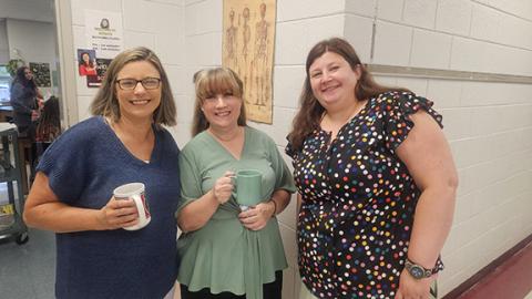 Nicole Wright/Staff Correspondent A little “coffee klatch” before homeroom as (from left) science teacher Bethany Clark, art teacher Ann Williams and math teacher Jenni Cable direct new and returning students to their classrooms Monday morning. 