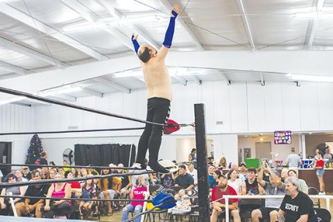 Cannon Crompton/sports@cherokeescout.com Frodo stands on the ropes before his match as the crowd loudly cheers at the ACWF’s Summer Showdown on Saturday night at the Peachtree Community Center. 