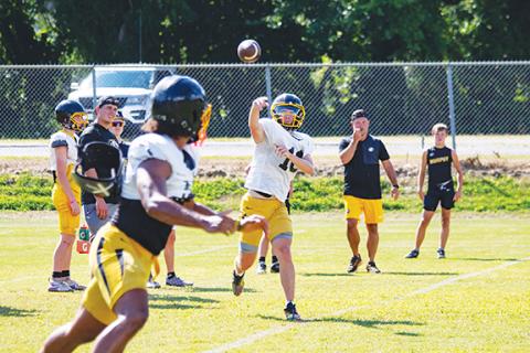 Cannon Crompton/sports@cherokeescout.com Murphy Bulldogs quarterback Brady Grant throws a pass to Cameron Clem during preseason training camp on Aug. 6. 