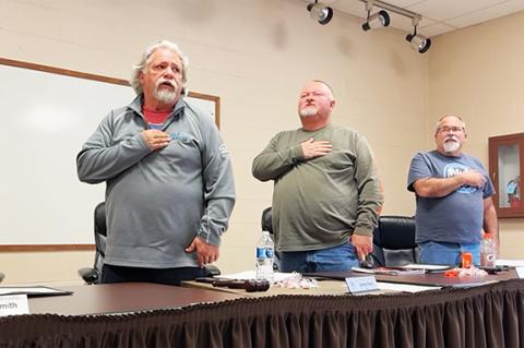 The Andrews Board of Aldermen recite the pledge during a meeting earlier this year. From left are Mayor James Reid, Alderman James Mclean and Alderman Ted Paul.