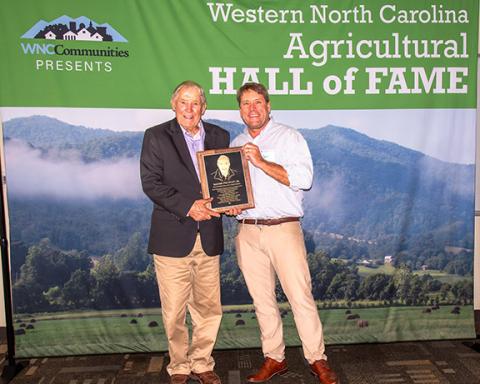 Bass Hyatt (left) with Jamie Ager, Hickory Nut Gap Farm co-founder, who inducted him into the WNC Ag Hall of Fame.