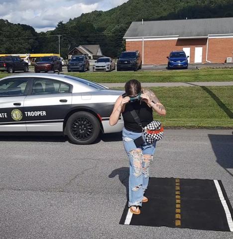 Photos by Anngee Quinones-Belian/Staff Correspondent   Meghan Torres of Martins Creek appeared to loose her balance and clearly wasn’t able to walk on the white line of the simulated roadway. The N.C. Highway Patrol brought out their DUI goggles for folks to put on, giving the wearer the illusion of being impaired by alcohol or drugs.