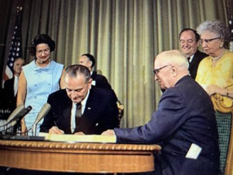 President Lyndon B. Johnson signed into law the Medicare and Medicaid Act on July 30, 1965.