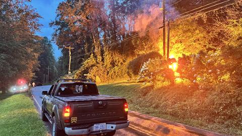 Randy Foster/editor@cherokeescout.com Valleytown Fire & Rescue personnel stand by as a downed power line arcs on a stand of bushes off of Pisgah Road in Andrews on the evening of Aug. 22. A branch or tree fell on the live line, cutting power to Duke Energy customers south of impact. Firefighters arrived shortly after 8 p.m. Friday and stood watch until a Duke Energy line workers arrived and restored power. There were no injuries and no property damage, aside from the vegetation and power line.