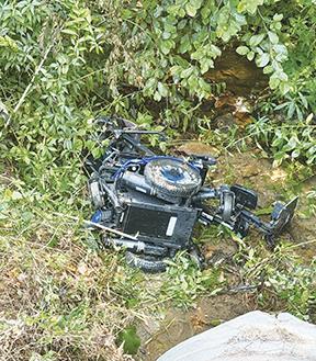 Randy Foster/ editor@cherokeescout.com A motorized wheelchair marks the scene Friday where an elderly nearby resident in the 400 block of Wilson Road in Brasstown fell in to Stamey Branch and was pinned down by his wheelchair until rescuers arrived.