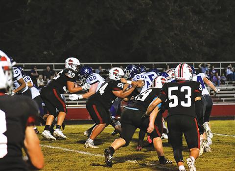 Bre Woodard/Staff Correspondent  The Andrews defense lines up against Mitchell in the Wildcats’ home opener Friday night.
