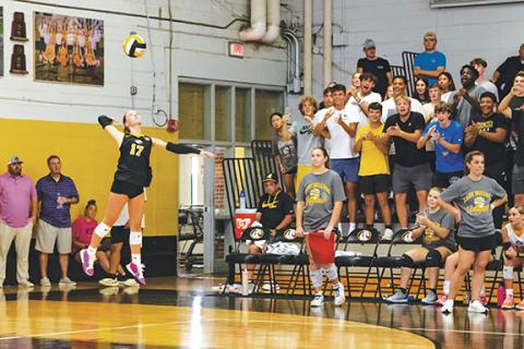 Cannon Crompton/sports@cherokeescout.com Lady Bulldog Saddie Cornwell serves with the support of the Murphy student section loudly cheering her on Sept. 16. 