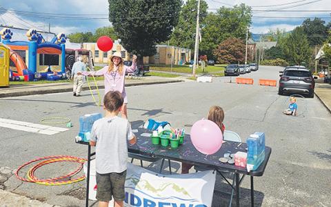Photos by Nicole Wright/Staff Correspondent Andrews Chamber of Commerce Executive Director Sara Posey Davis gets into the swing at the Kids Zone during Saturday’s Oktoberfest celebration on Main Street.