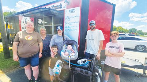 Nicole Wright/Staff Correspondent Silas Morrow and family were able to attend the fundraiser Saturday sponsored by A&J’s Adventures & More at White’s Plaza in Andrews. From left are Julie Pendergrass of A&J’s, Annette Palmer of A&J’s, Samuel Morrow, Julie Morrow, baby Silas, Adam Morrow and Brayden Morrow. The benefit raised more than $5,000 for the family’s ongoing medical and travel expenses. 