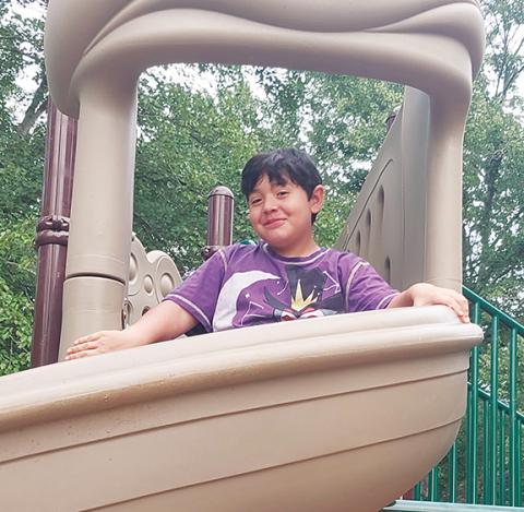 Phillip Davis/Contributing Photographer Dominic Miguel was the first person to try out the new slides at Konehete Veterans Park in Murphy.