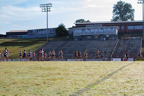 Cannon Crompton/sports@cherokeescout.com Girls varsity cross-country runners run across David Gentry Field at Murphy High School to start the 5K course Saturday morning. 