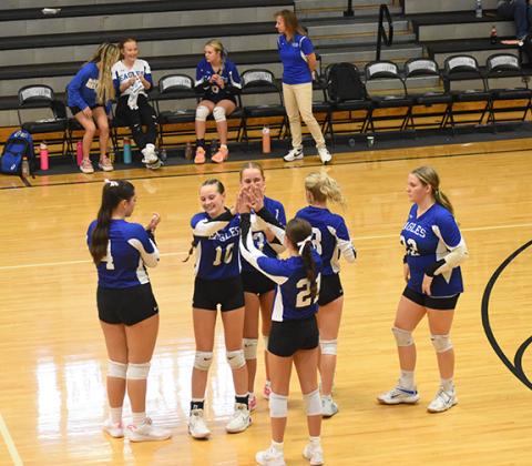 Lexie Anderson/The Graham Star The Lady Eagles celebrate scoring a point against Robbinsville on Sept. 2.
