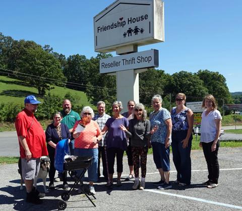 Bill Belian/Contributing Photographer Community leaders and supporters gather to say goodbye to years of mortgage payments at the Friendship House Reseller thrift store on U.S. 64 West in Murphy.
