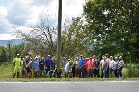 Randy Foster/editor@cherokeescout.com Local bicycle enthusiasts pose at a roadside “Ghost Bike” memorial commemorating the life of Frank Mason, 80, of Andrews. Mason was struck by a vehicle while riding his bike on Airport Road in Marble on Aug. 12. He succumbed from his injuries on Aug. 18. BikeFriendlyAtlanta was contacted regarding Mason’s death. The organization came to Airport Road in Andrews where the fatal accident occurred to place a “Ghost Bike” at the accident site. A Ghost Bike is a bicycle that 
