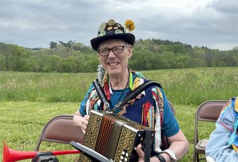 Carl Dreher prepares to play music at May Day at John C. Campbell Folk School in this frame from the documentary.
