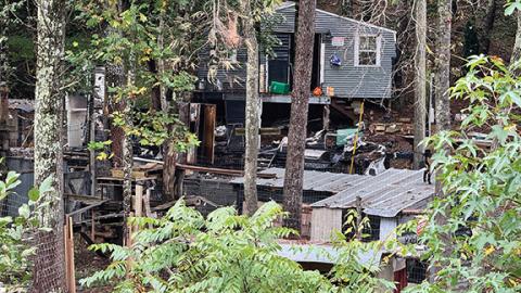 Randy Foster/editor@cherokeescout.com Crime scene tape remains at the location of a camper trailer fire in Wolf Creek, where a woman’s remains were later found.
